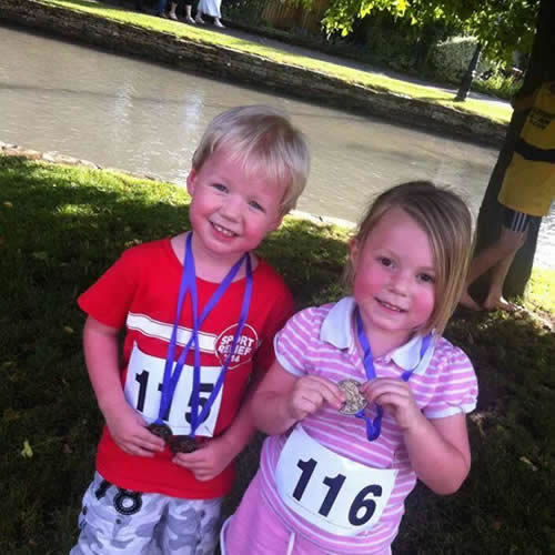 Twins Robbie and Daisy Reeve (Bourton Roadrunners' future stars) proudly display their fun run medals