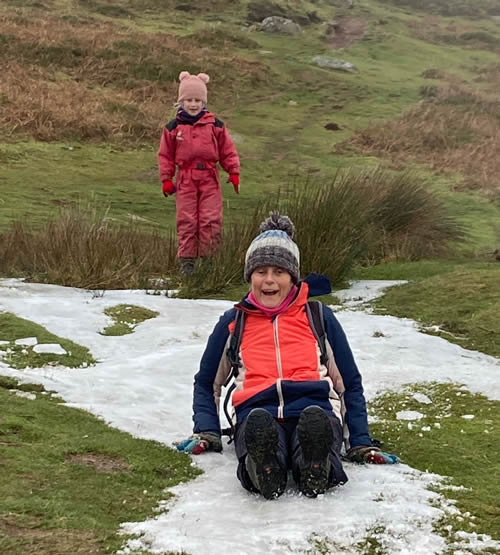 Margaret with 6 year old granddaughter, sledging having climbed Sugar Loaf. Click on image for a larger version